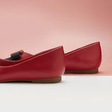 Chic and sophisticated red leather flats with decorative details