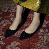 Black point-toe suede flats for a sleek and stylish look.