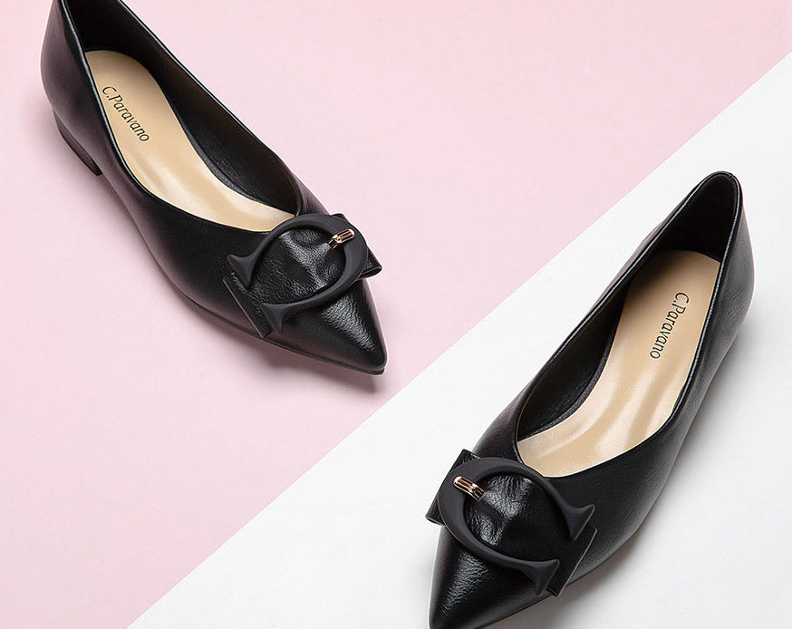 Elevate your style with black grain leather point-toe flats.