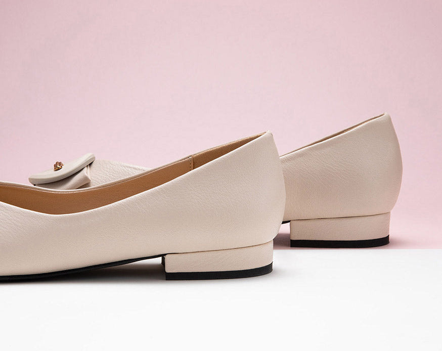 White grain leather flats with a stylish pointed toe